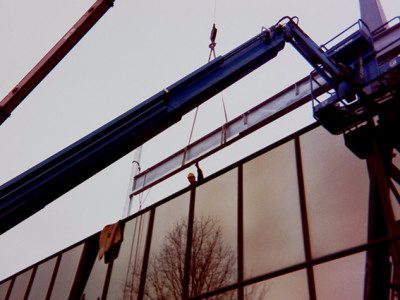 Metal beams being lifted by a crane